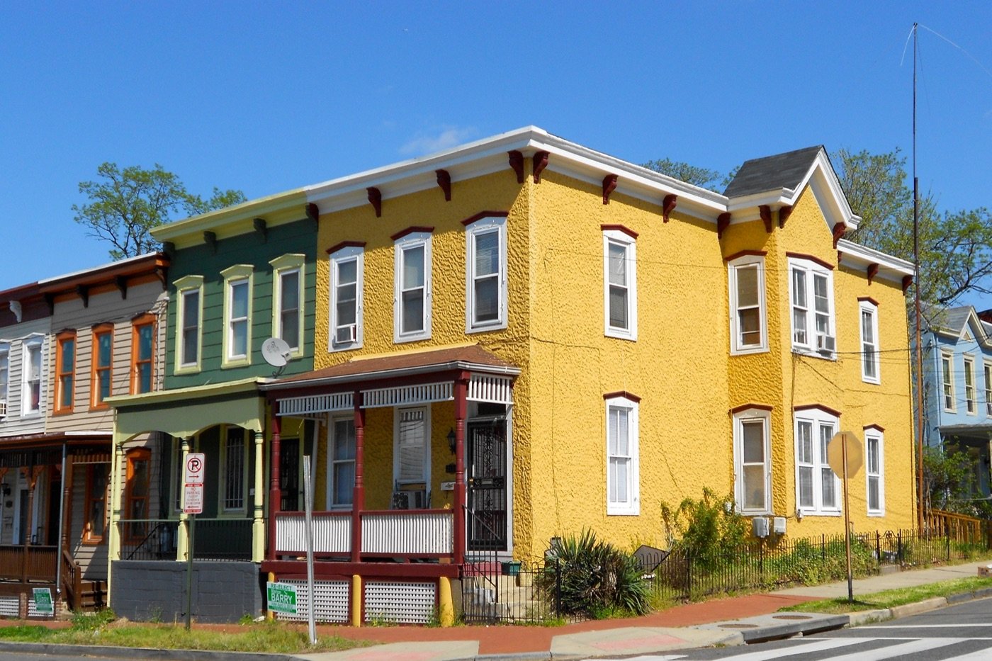 Yellow and green Victorian row houses on 13th and W Street in the Anacostia Historic District in Washington DC near Anacostia Organics