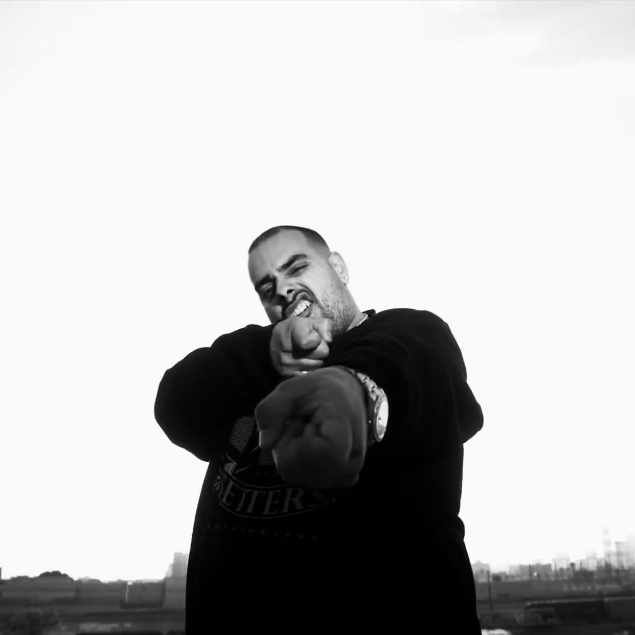 Cookies founder Berner pointing at the camera in a black sweatshirt and chain in a black-and-white promotional portrait