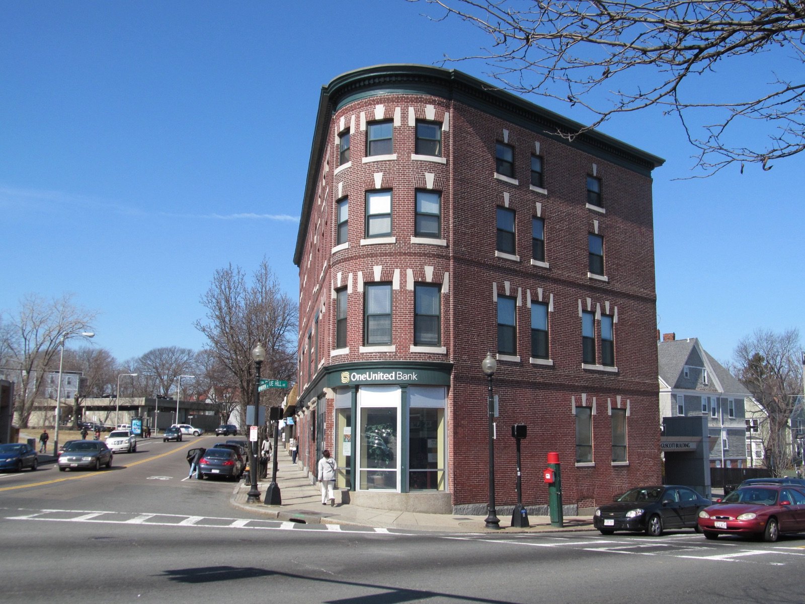 Three-story brick OneUnited Bank building on the corner of Blue Hill Avenue in the Grove Hall section of Dorchester Boston