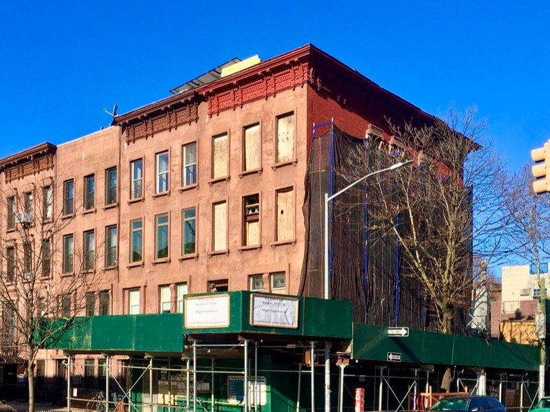 Brooklyn street corner at Nostrand Avenue and Greene Avenue in Bedford-Stuyvesant with subway entrance and corner store