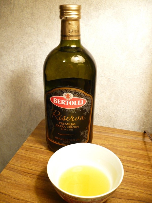 Dark glass olive oil bottle, the recommended storage format for keeping infused oil shelf-stable and light-protected