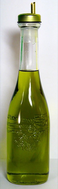 Italian extra virgin olive oil in a glass cruet, the cold-finish format for drizzling on plated food