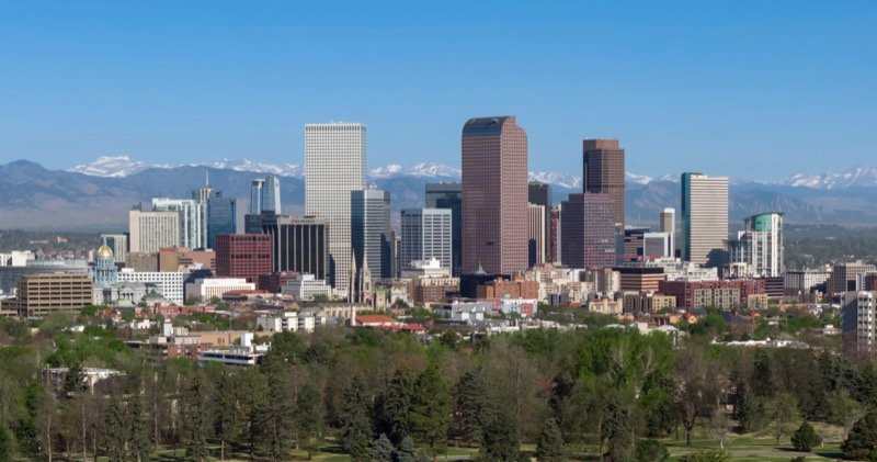 Downtown Denver skyline with the Colorado State Capitol gold dome and the Rocky Mountains in the distance