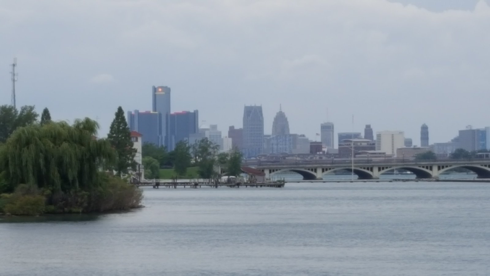 Detroit skyline including the Renaissance Center viewed from Belle Isle Park across the Detroit River with the MacArthur Bridge in the foreground