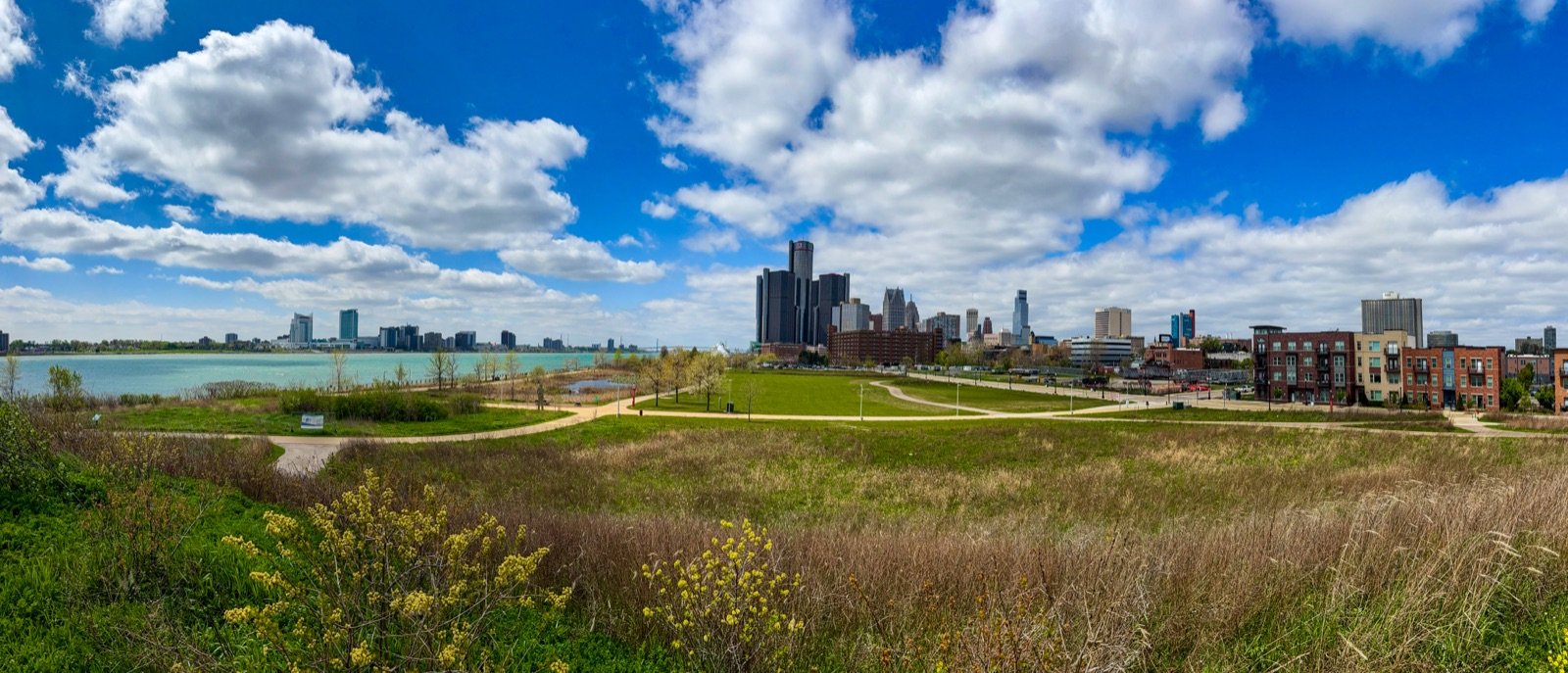 Detroit skyline panorama from the Riverwalk with Renaissance Center towers and the Detroit River in foreground