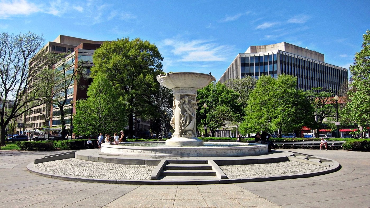 Dupont Circle fountain facing southwest with Connecticut Avenue NW office buildings behind it in Washington DC near National Holistic Healing Center