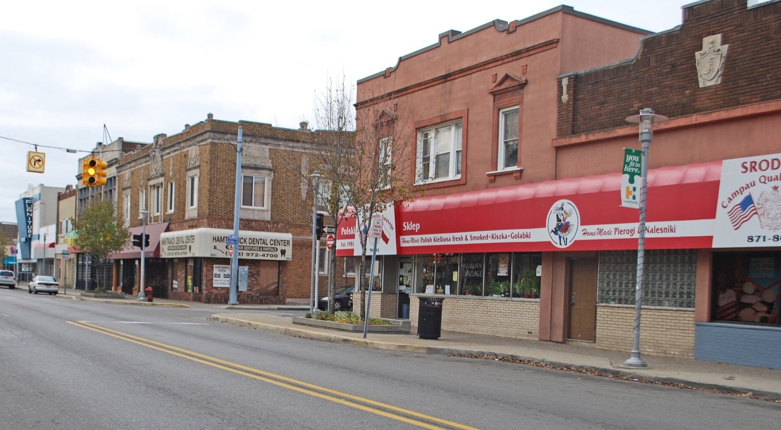 Joseph Campau Avenue in Hamtramck Michigan with the Polish Sklep deli storefront awning and historic two-story commercial buildings in the Joseph Campau Historic District