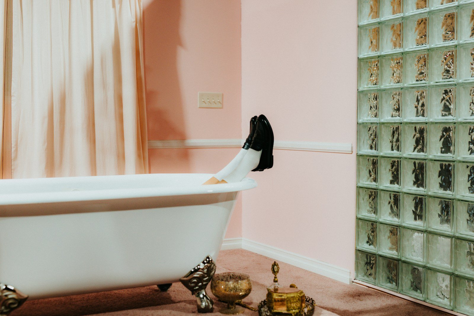 Vintage clawfoot bathtub with feet sticking up in flippers evoking the Dude submerged in his bath with Creedence on cassette