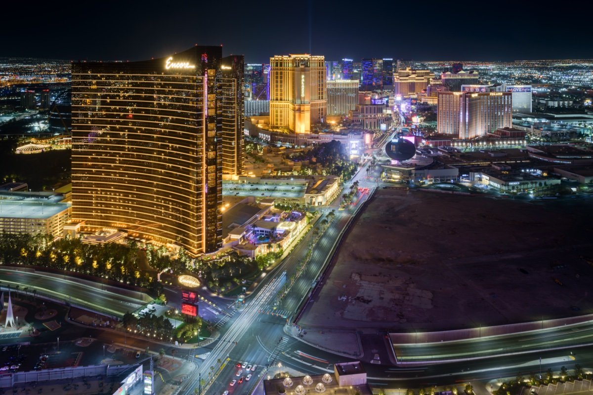 Las Vegas Strip skyline at night looking north from Resorts World, with Wynn and the Sphere in view.