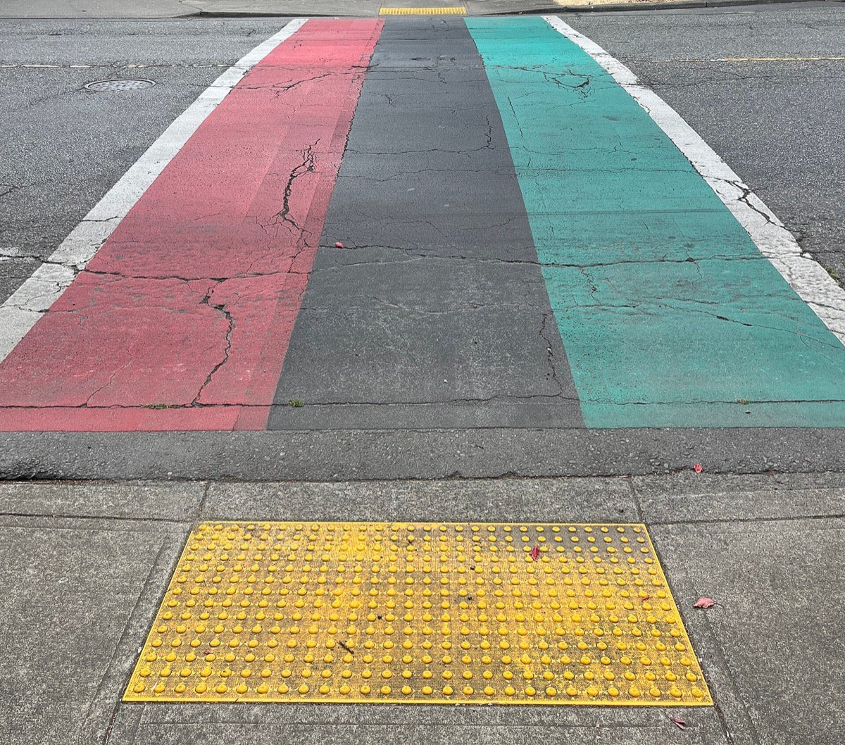 East Union Street pedestrian crossing painted in the Pan-African flag colors in Seattle's Central District near Ponder Super Chronic Club