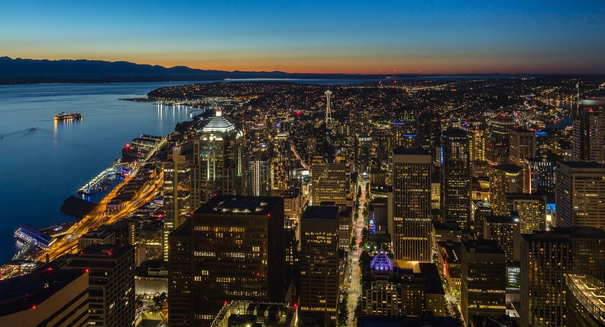 Seattle skyline at sunset with the Space Needle and Mount Rainier on the horizon