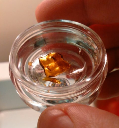 Cannabis shatter concentrate in a small glass jar, representative of the THC concentrate category Silly Nice produces from its Harlem-rooted operation