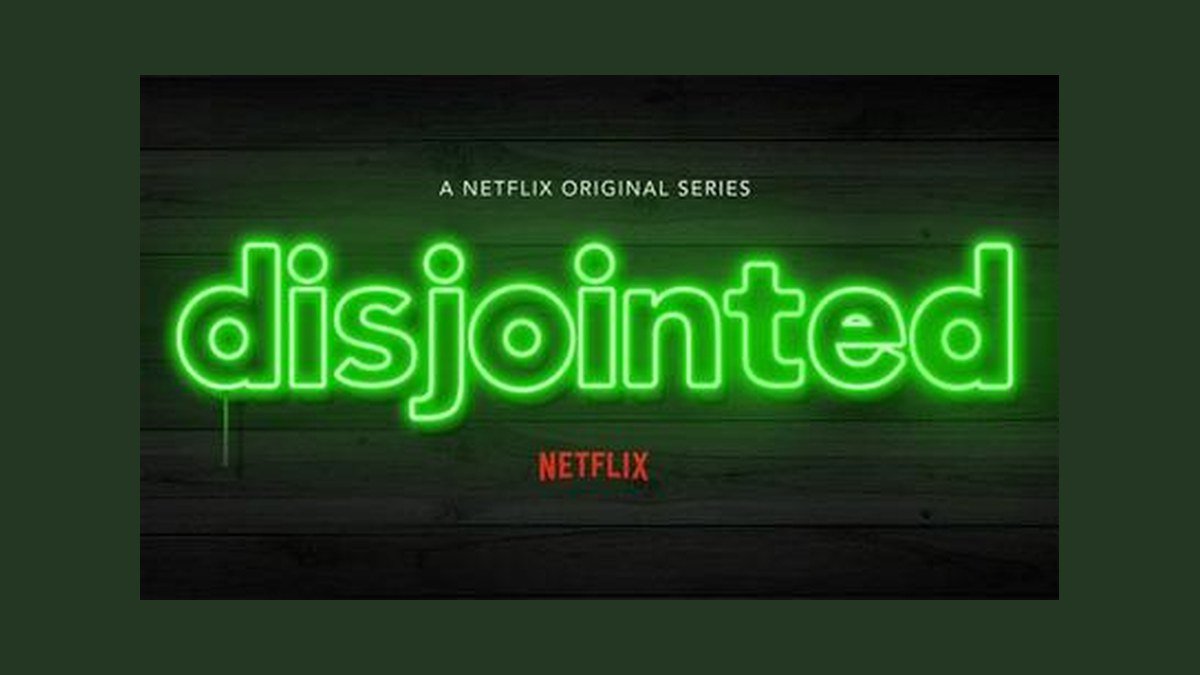 Disjointed Netflix neon dispensary logo on a wood paneled backdrop