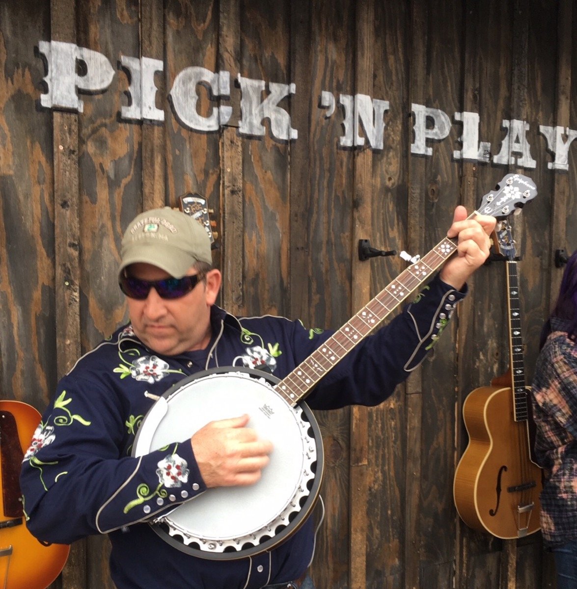 Musicians picking guitars at Willie Nelsons Luck Ranch outside Spicewood Texas, the Old West movie set that hosts the annual Luck Reunion festival every March and integrates cannabis sponsorship in ways mainstream country festivals do not