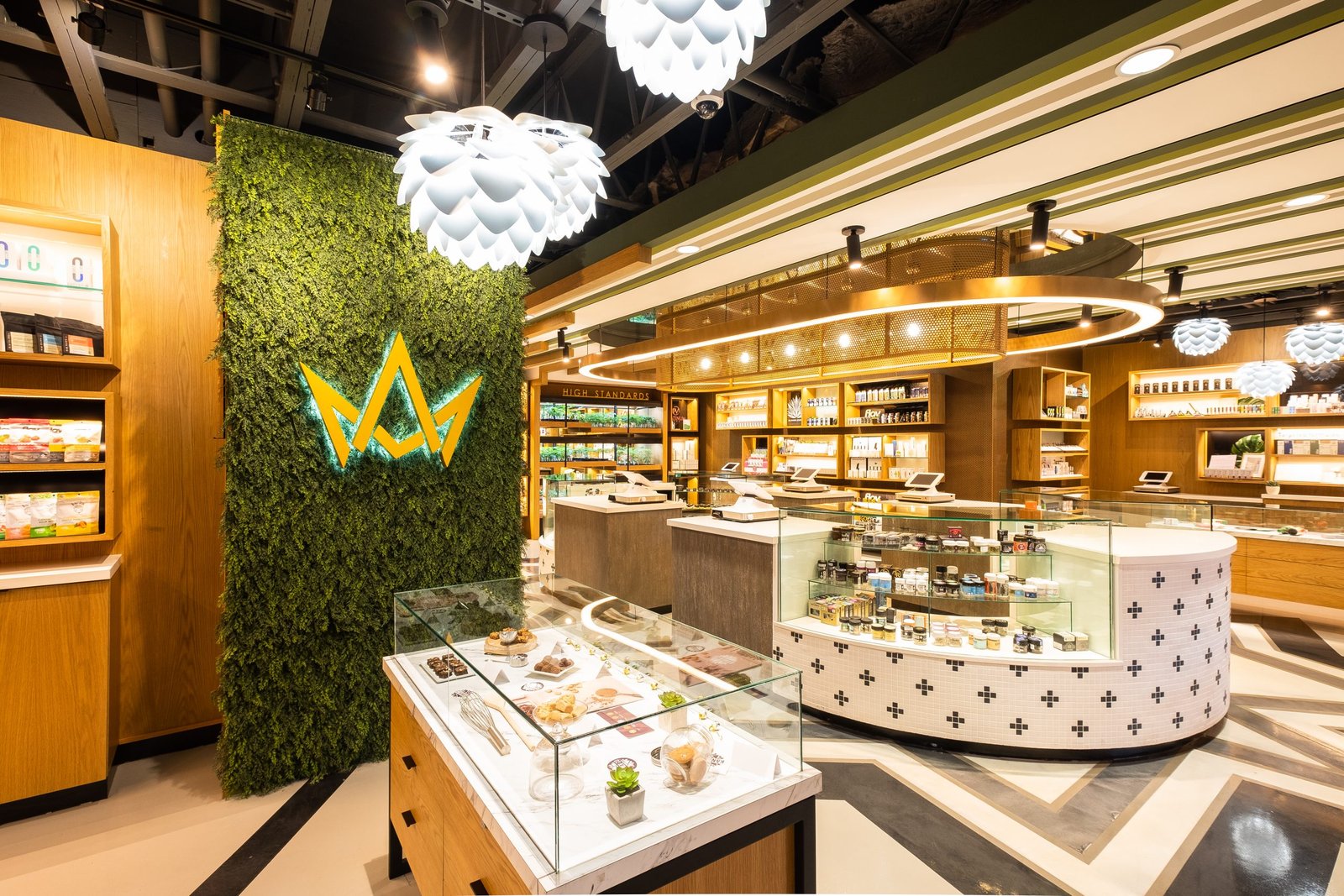 March and Ash Mission Valley flagship retail floor in San Diego with the dispensary's crown logo on a green wall