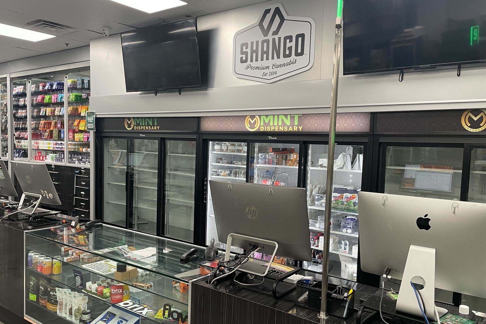 Mint Cannabis Tempe checkout counter with Shango branded cooler in the background