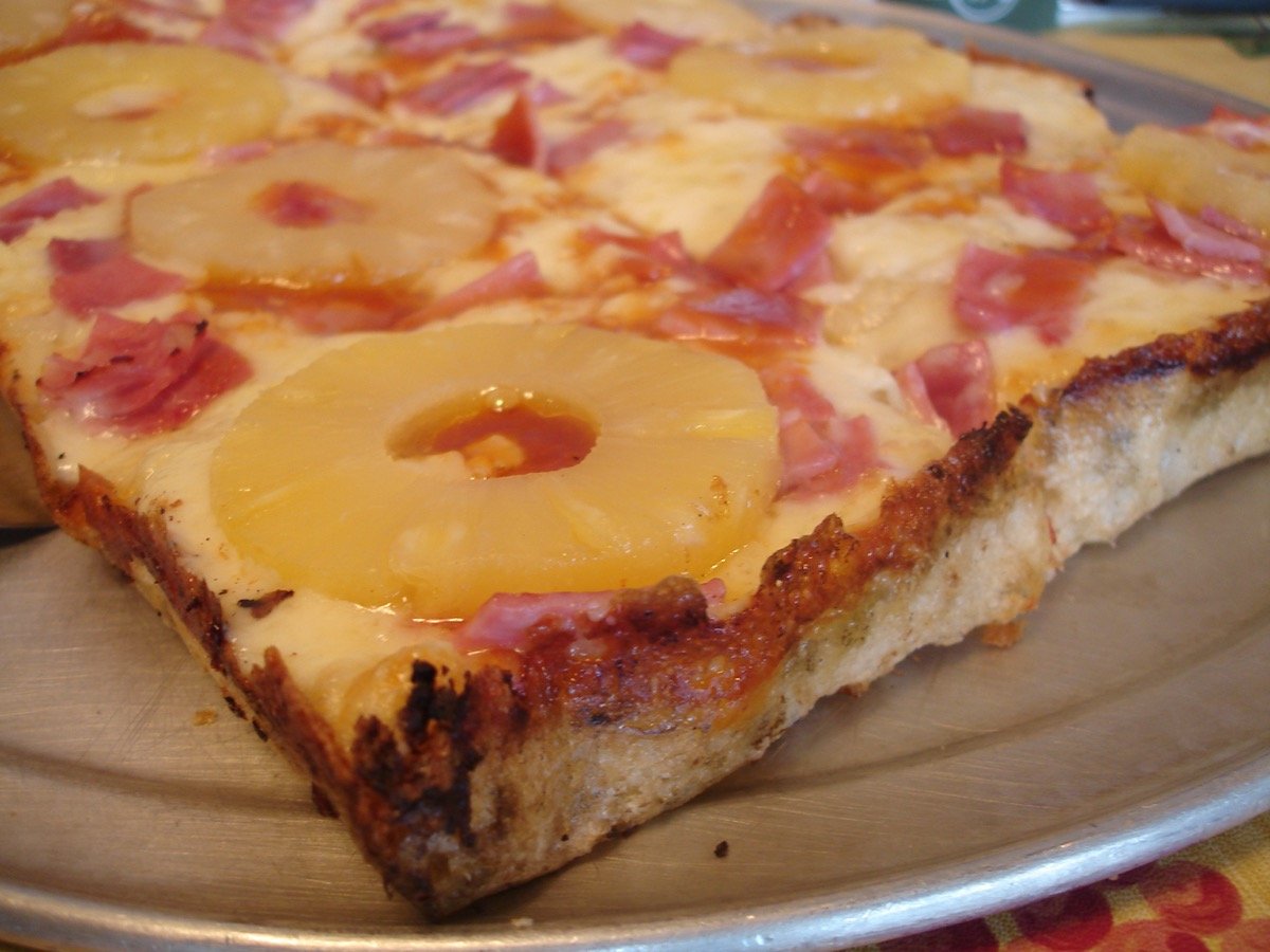 Ham and pineapple flatbread cut into squares for the Saul apartment cross joint scene in Pineapple Express