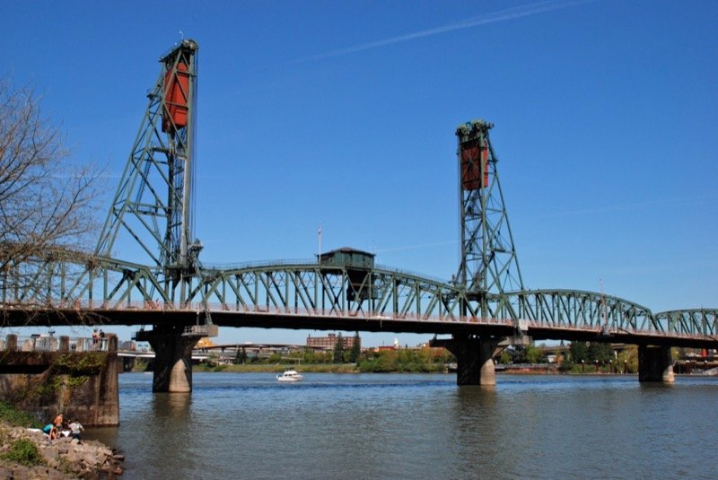 Hawthorne Bridge over the Willamette River with downtown Portland skyline behind it