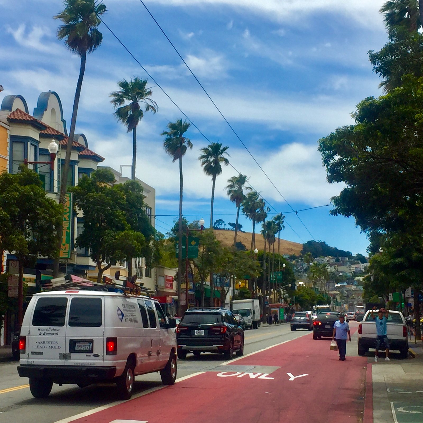 Mission Street with palm trees and Bernal Heights in the background in the Mission District of San Francisco near Mission Cannabis Club at 2441 Mission