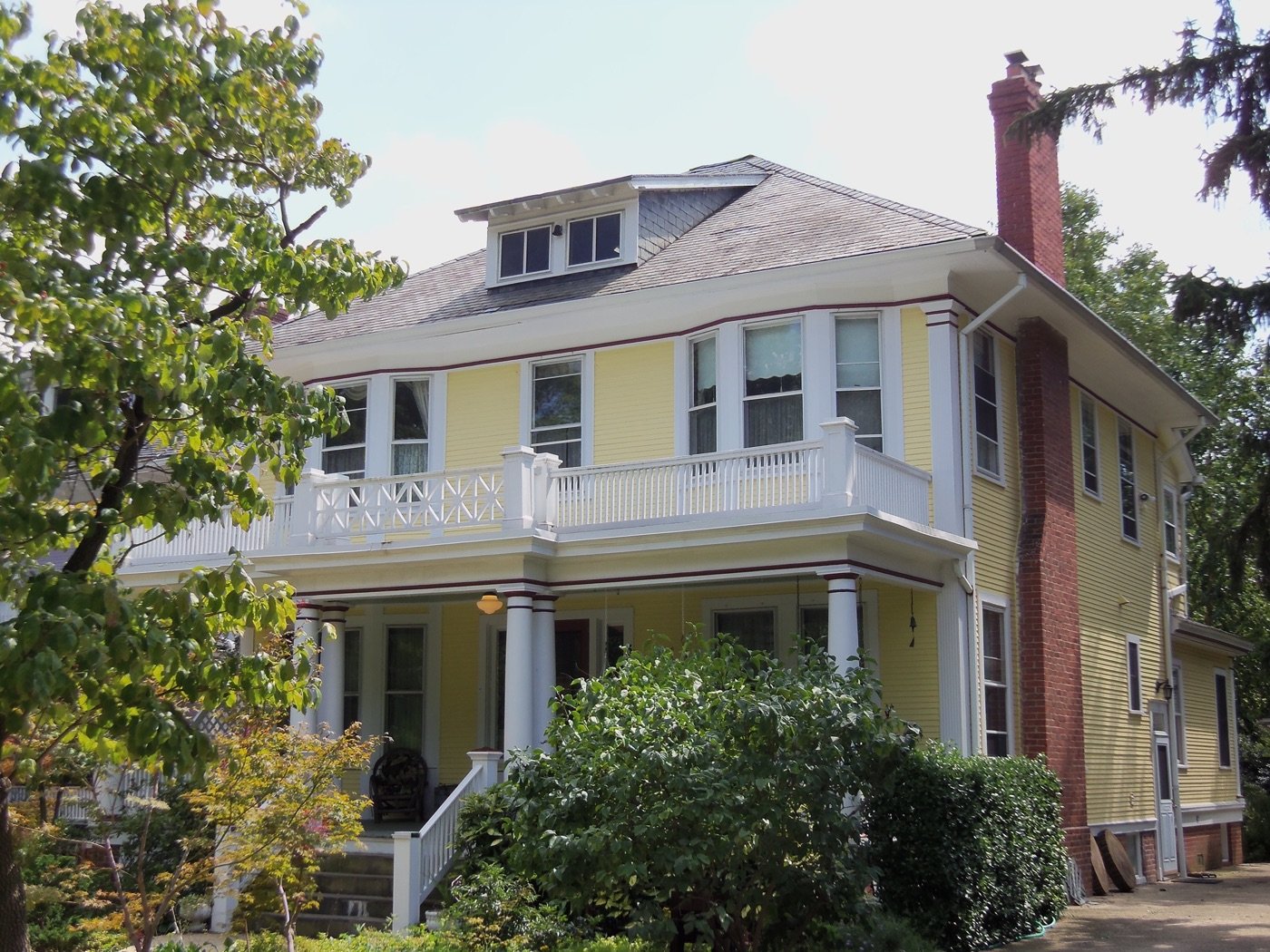 Yellow Victorian Foursquare house in the Takoma Historic District of Washington DC near Takoma Wellness Center on Blair Road NW