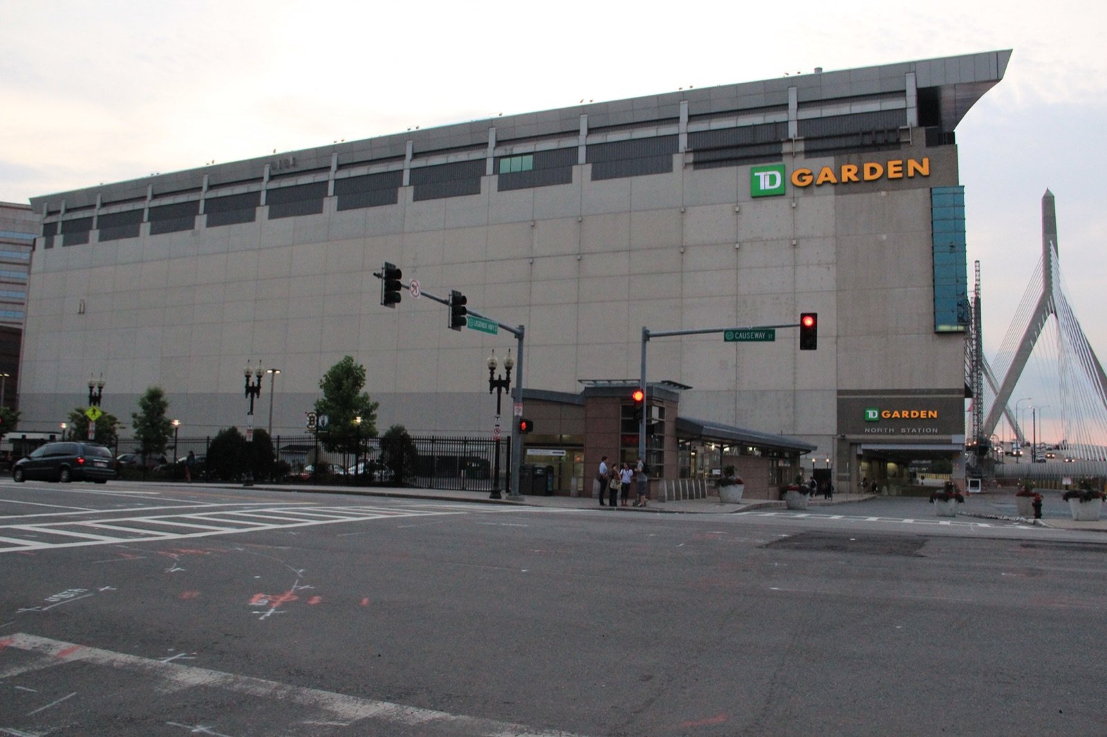 TD Garden arena exterior at North Station with the Leonard Zakim Bunker Hill Bridge cable-stay tower visible at right in Boston West End