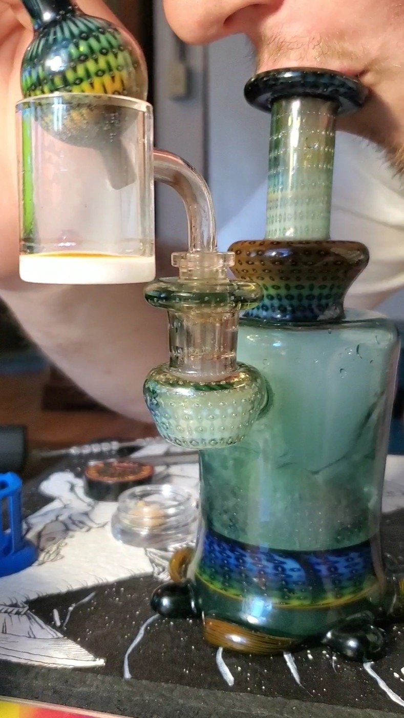 Cannabis concentrate being dabbed off a glass rig representing the Twenty-Two K GMO Cookies side