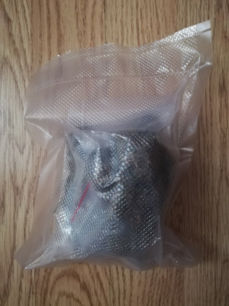 Roughly an ounce of dried cannabis buds packed in a sealed bag, the maximum single-transaction purchase in most adult-use states