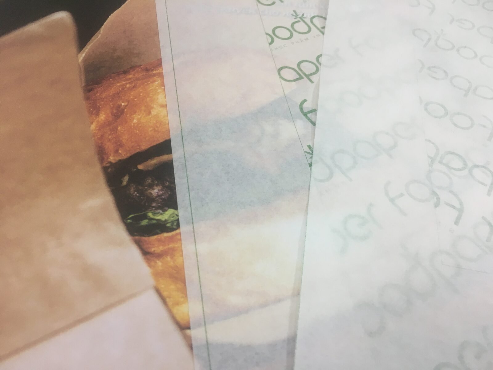 Roll of parchment baking paper partially unrolled on a kitchen surface, the silicone-coated paper people ask about using to roll weed