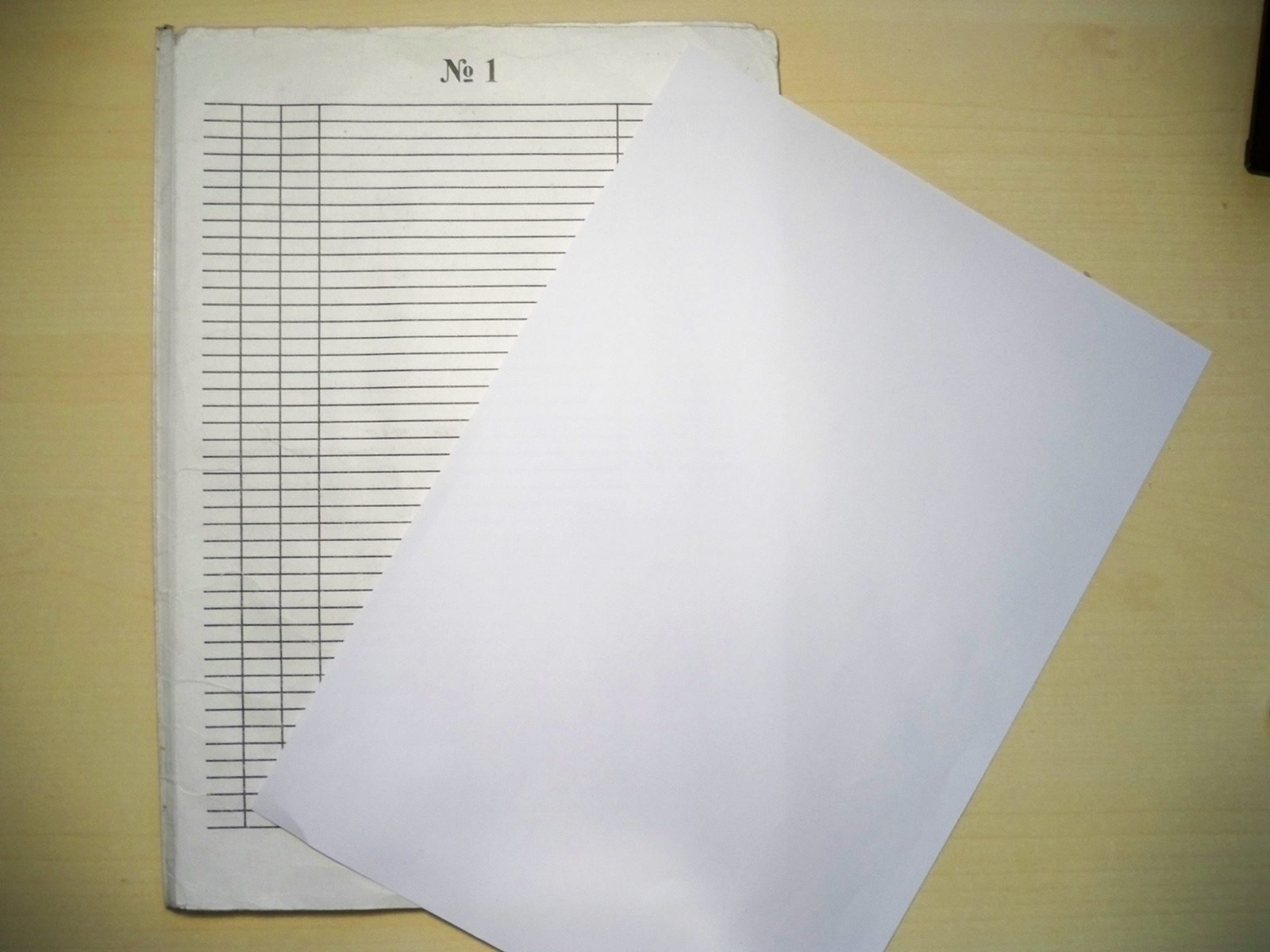 Sheet of ruled notebook paper with blue horizontal lines