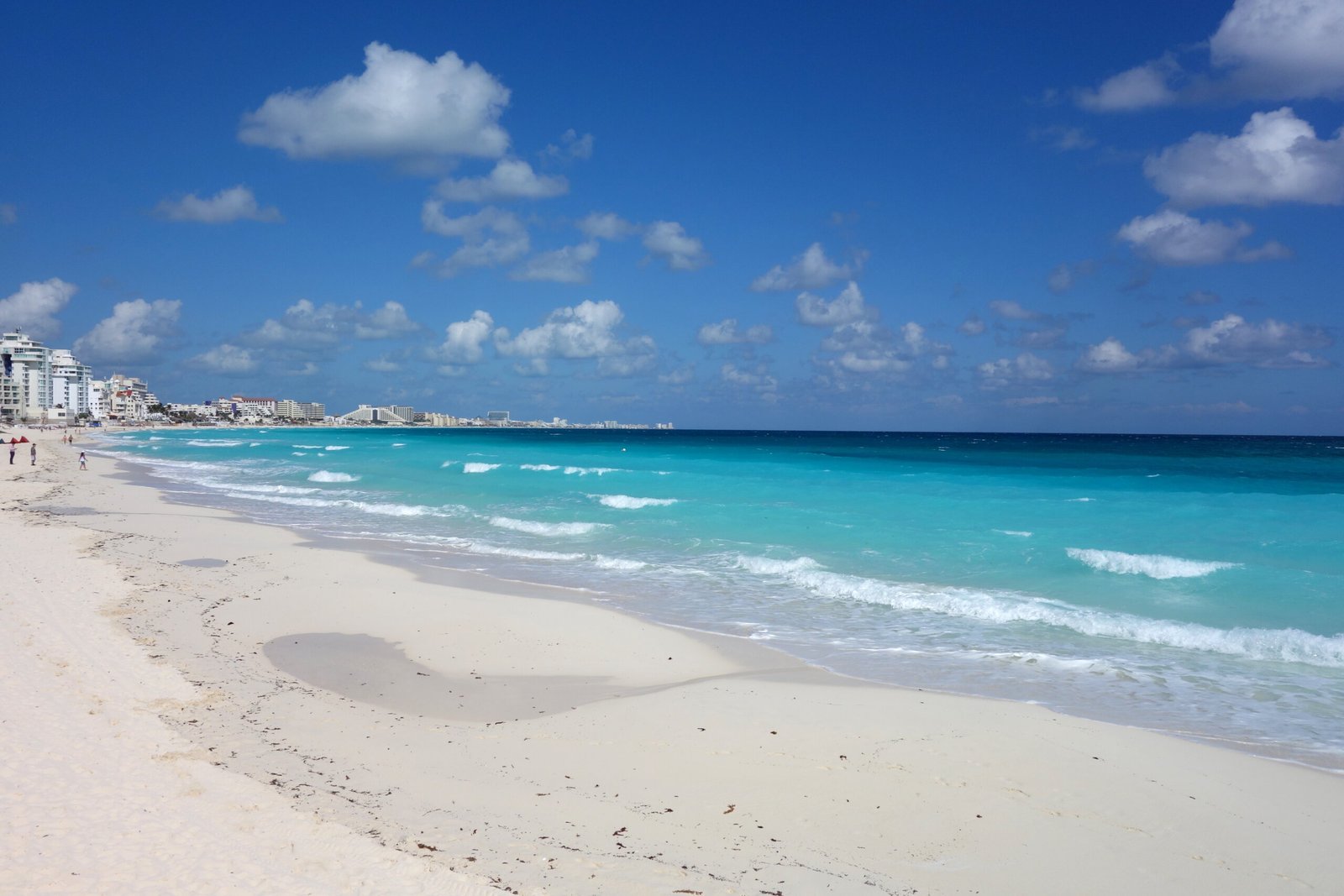 Turquoise Caribbean water and white sand along the Cancun hotel zone, the tourist strip where most visitors ask about cannabis